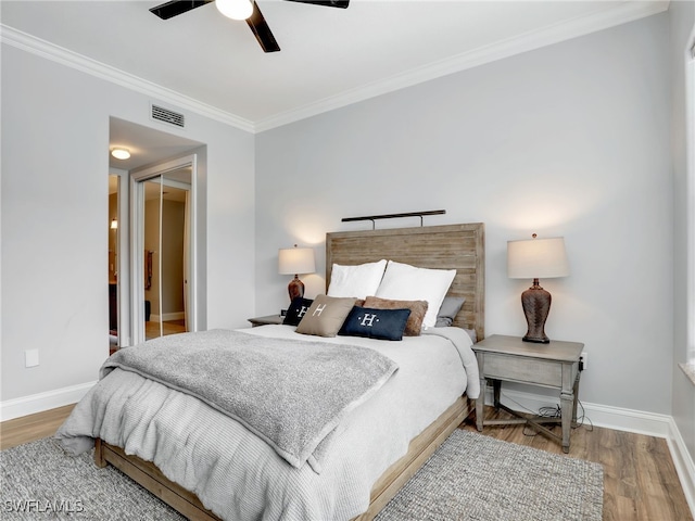 bedroom featuring crown molding, hardwood / wood-style floors, and ceiling fan