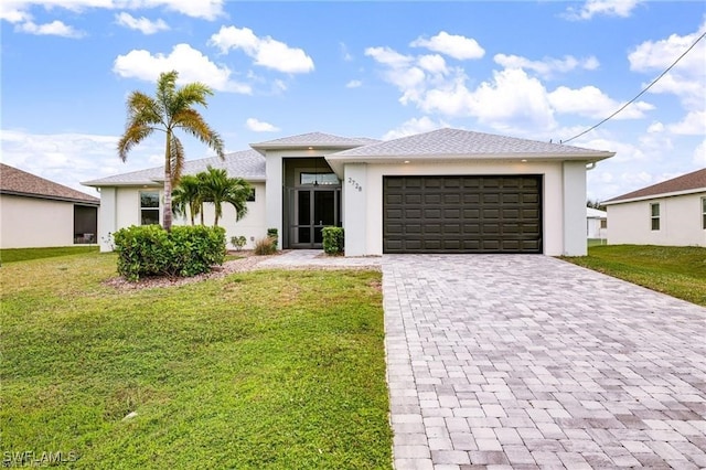 view of front of home with a garage and a front lawn