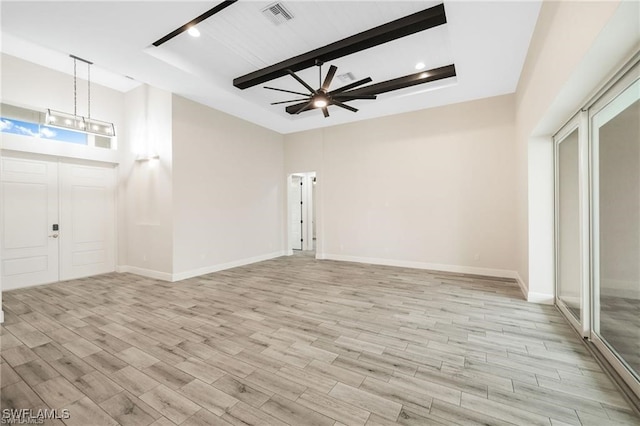 foyer entrance featuring beamed ceiling and ceiling fan