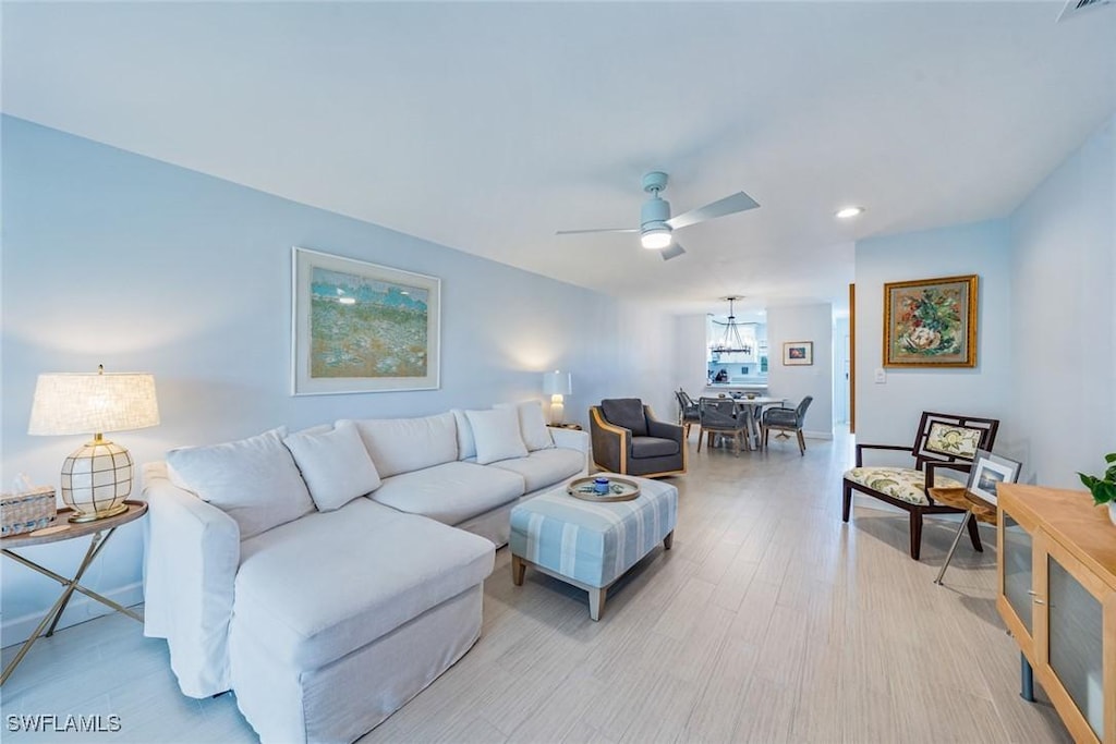 living room featuring ceiling fan and light hardwood / wood-style flooring