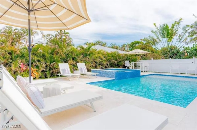 view of pool with an in ground hot tub and a patio