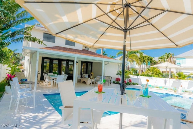 exterior space featuring french doors and a fenced in pool