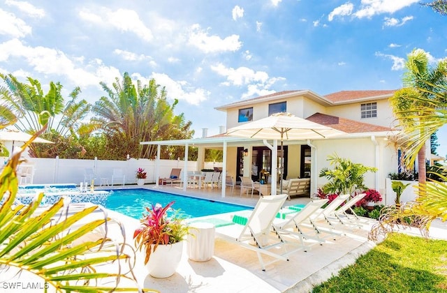 view of swimming pool with pool water feature and a patio area