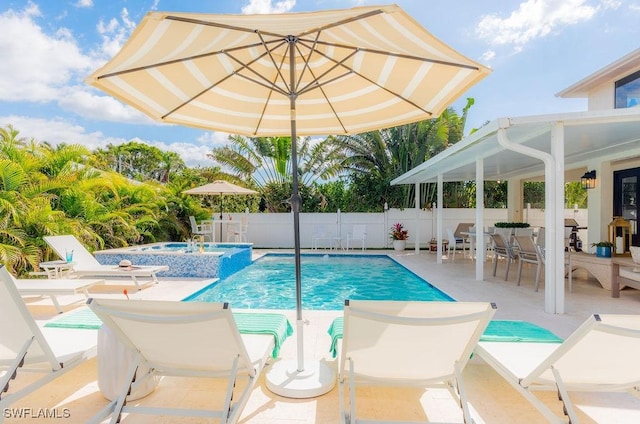 view of swimming pool featuring an in ground hot tub and a patio area