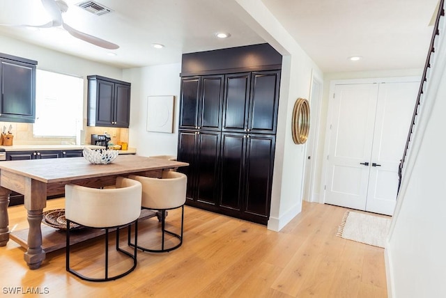 kitchen with tasteful backsplash, ceiling fan, and light wood-type flooring