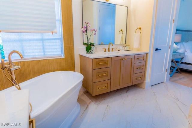 bathroom with vanity and a washtub