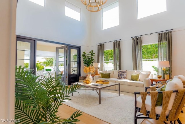 living room with wood-type flooring and a notable chandelier