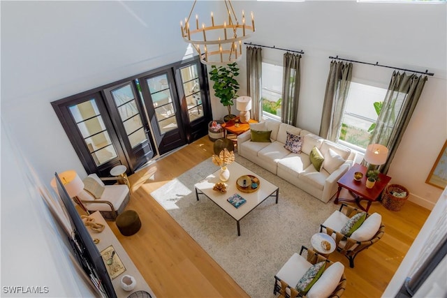 living room featuring wood-type flooring and a chandelier