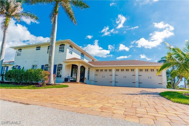 mediterranean / spanish-style home with a garage