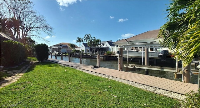 view of dock with a lawn and a water view