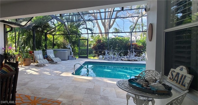 view of pool with a hot tub, a patio, and glass enclosure