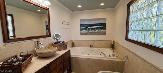 bathroom with vanity, a bidet, and a relaxing tiled tub