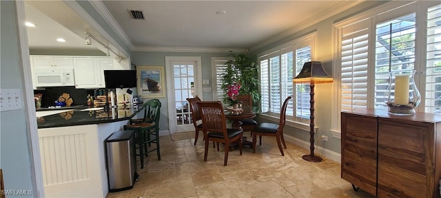 dining area with crown molding