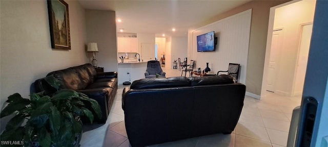 living room with sink and light tile patterned floors