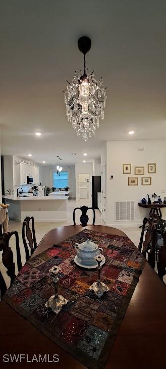 dining area with an inviting chandelier