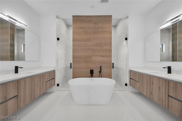 bathroom featuring vanity and shower with separate bathtub