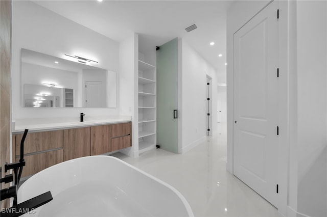 bathroom with vanity and a bath