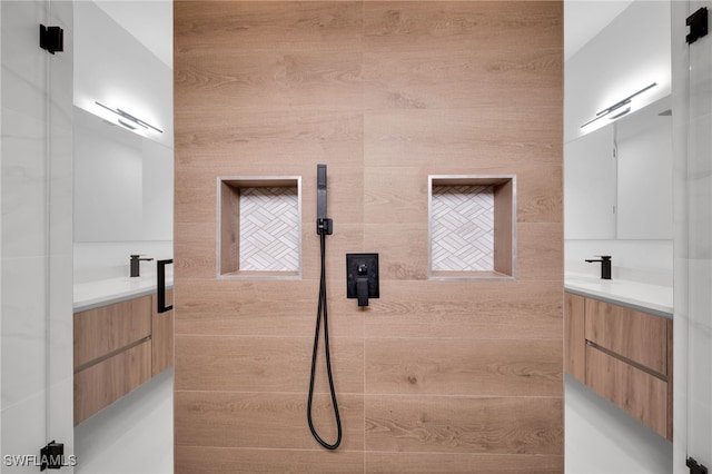 bathroom featuring vanity, tiled shower, and wood walls