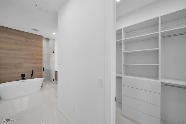 interior space with a washtub and wood walls