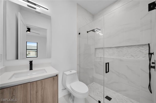 bathroom featuring a shower with door, vanity, and toilet