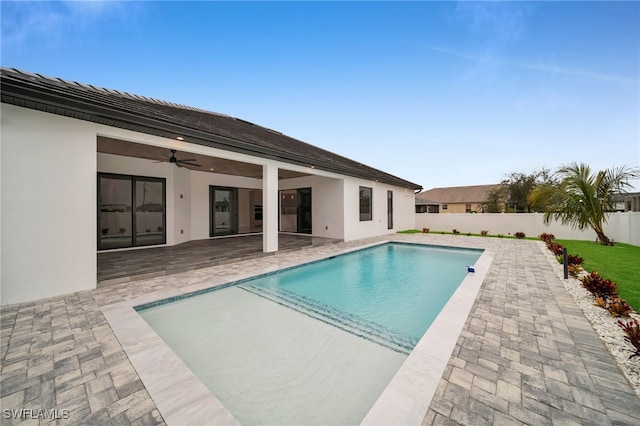 view of pool featuring ceiling fan and a patio area