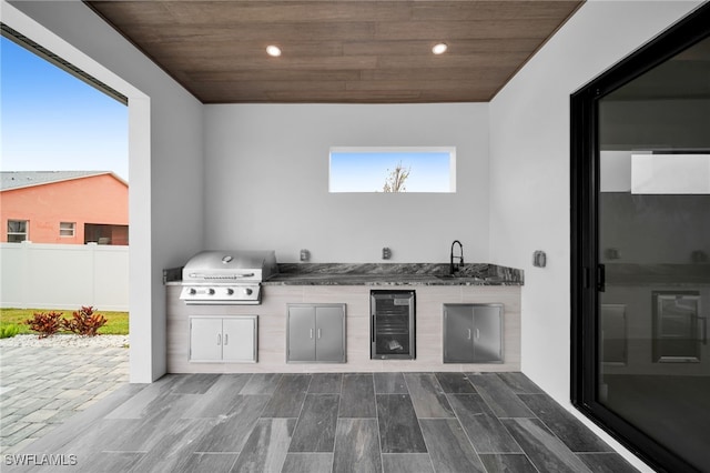 view of patio / terrace featuring area for grilling, sink, and an outdoor kitchen