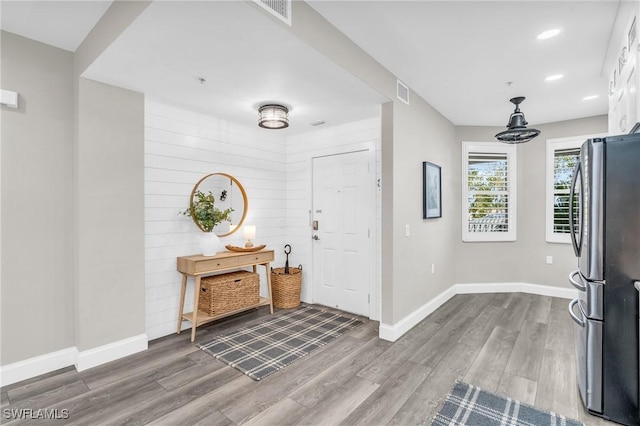 entryway with hardwood / wood-style floors