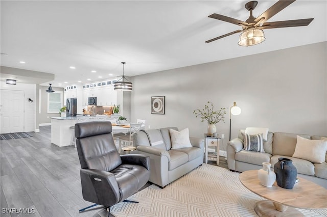 11041 Gulf Reflections Dr Unit 203, Fort Myers, FL 33908 - living room featuring ceiling fan and light wood-type flooring