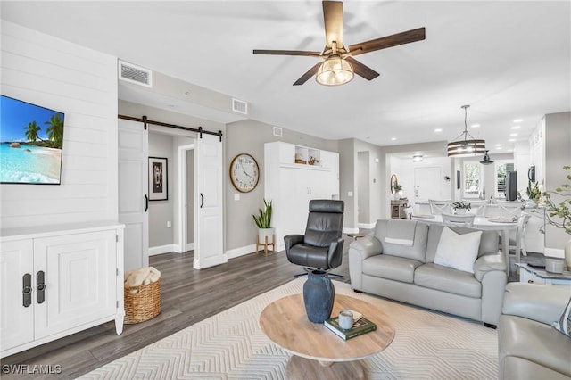 11041 Gulf Reflections Dr Unit 203, Fort Myers, FL 33908 - living room featuring a barn door, dark hardwood / wood-style floors, and ceiling fan