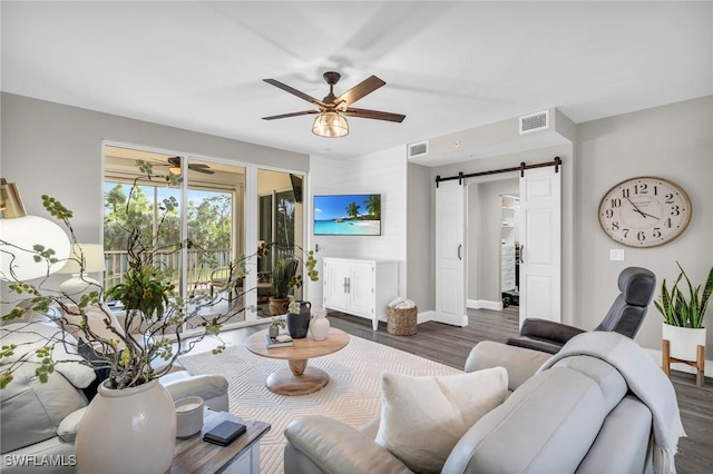 11041 Gulf Reflections Dr Unit 203, Fort Myers, FL 33908 - living room featuring ceiling fan, a barn door, and dark hardwood / wood-style flooring