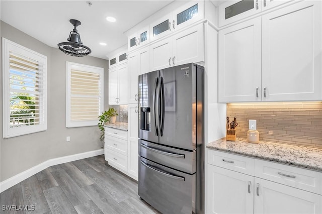 11041 Gulf Reflections Dr Unit 203, Fort Myers, FL 33908 - kitchen featuring refrigerator with ice dispenser, hanging light fixtures, light hardwood / wood-style floors, white cabinets, and decorative backsplash