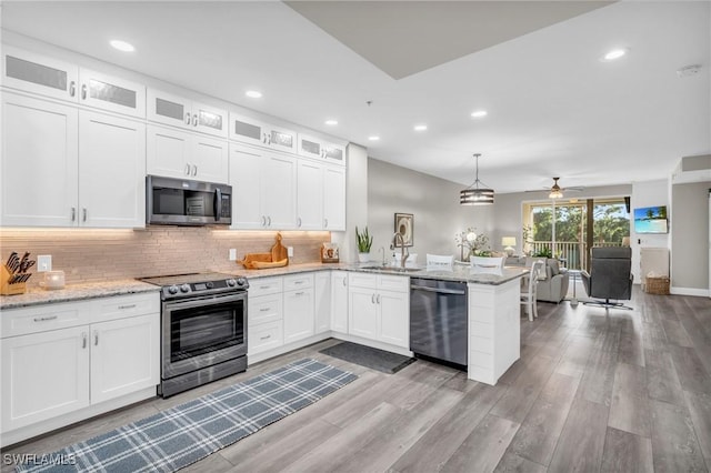 11041 Gulf Reflections Dr Unit 203, Fort Myers, FL 33908 - kitchen featuring white cabinetry, appliances with stainless steel finishes, and kitchen peninsula