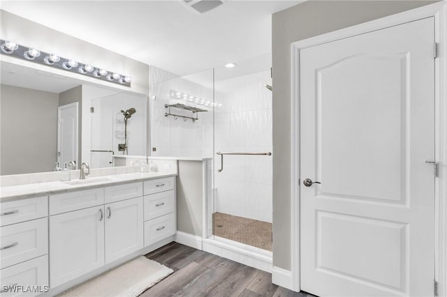 11041 Gulf Reflections Dr Unit 203, Fort Myers, FL 33908 - bathroom featuring vanity, hardwood / wood-style floors, and walk in shower