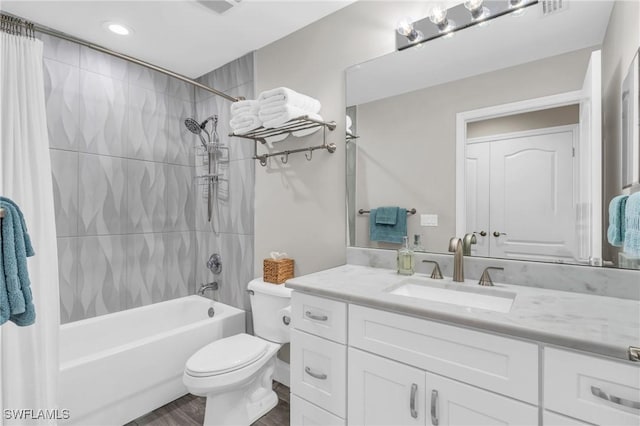 11041 Gulf Reflections Dr Unit 203, Fort Myers, FL 33908 - full bathroom featuring vanity, toilet, wood-type flooring, and shower / bath combo with shower curtain