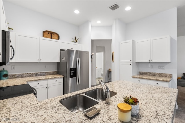 kitchen featuring sink, stainless steel appliances, and white cabinets