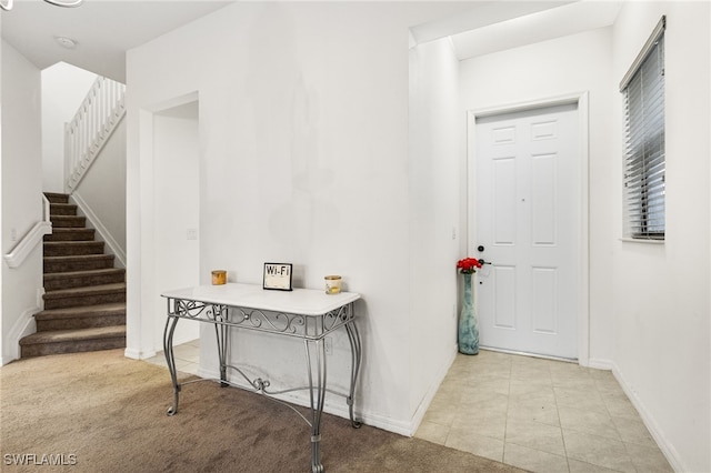 foyer entrance with light colored carpet