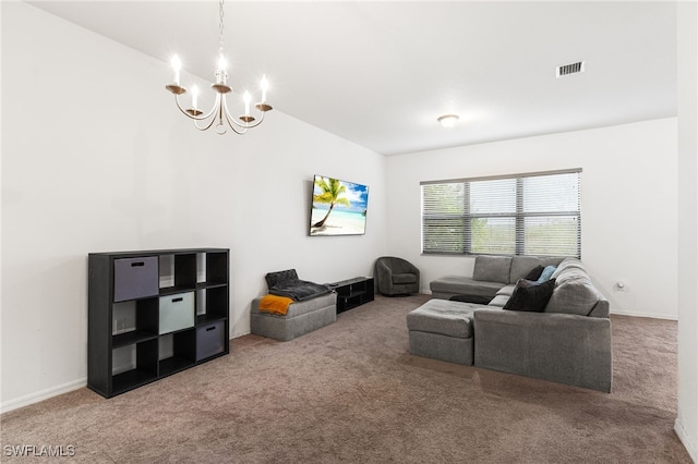 carpeted living room featuring a chandelier