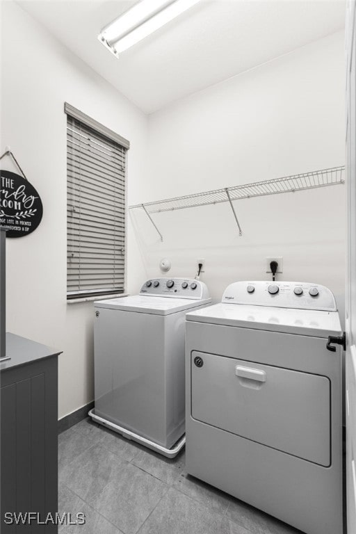 laundry room with tile patterned flooring and washer and dryer