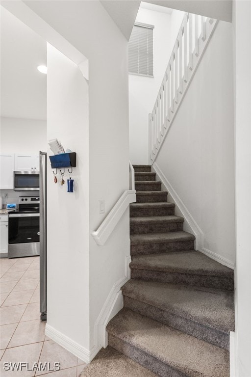 staircase featuring tile patterned flooring