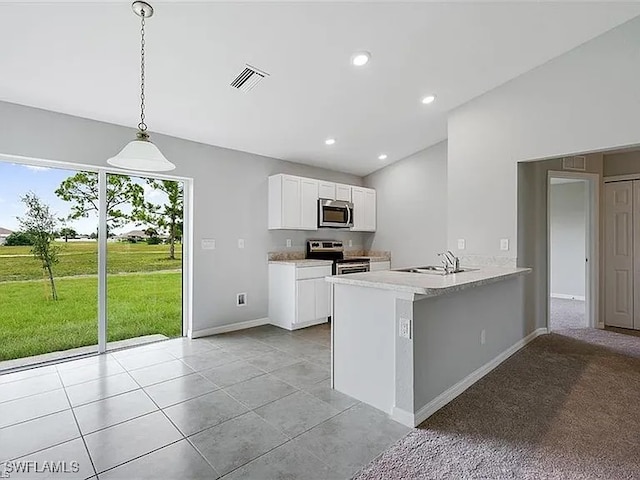 kitchen featuring sink, appliances with stainless steel finishes, kitchen peninsula, pendant lighting, and white cabinets