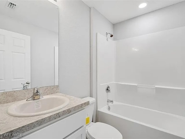 full bathroom with vanity, bathing tub / shower combination, and toilet