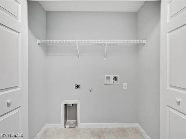 clothes washing area featuring hookup for a gas dryer, light tile patterned flooring, hookup for a washing machine, and hookup for an electric dryer