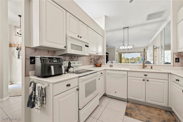 kitchen featuring light tile patterned flooring, sink, white cabinets, hanging light fixtures, and white appliances