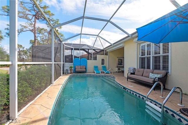 view of swimming pool with a patio, outdoor lounge area, and glass enclosure