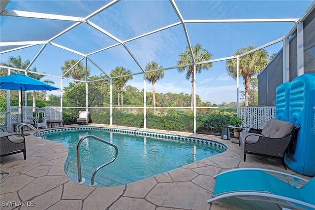 view of swimming pool with a patio and glass enclosure