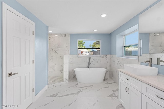 bathroom featuring vanity, independent shower and bath, and tile walls