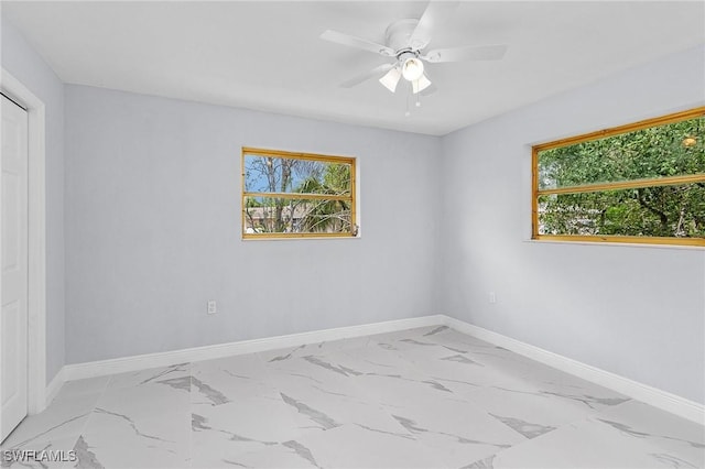 unfurnished room with a wealth of natural light and ceiling fan