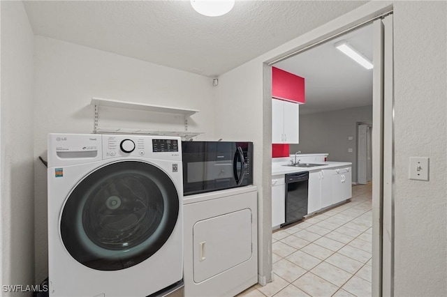 clothes washing area featuring sink, washer and clothes dryer, a textured ceiling, and light tile patterned flooring