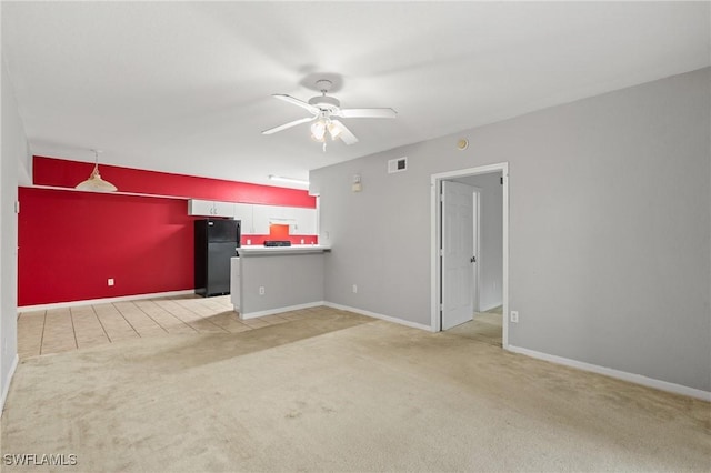 unfurnished living room with ceiling fan and light colored carpet