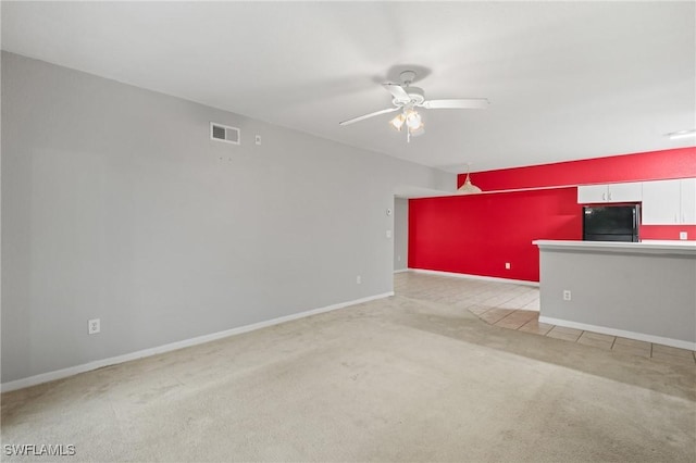 unfurnished living room with ceiling fan and light colored carpet